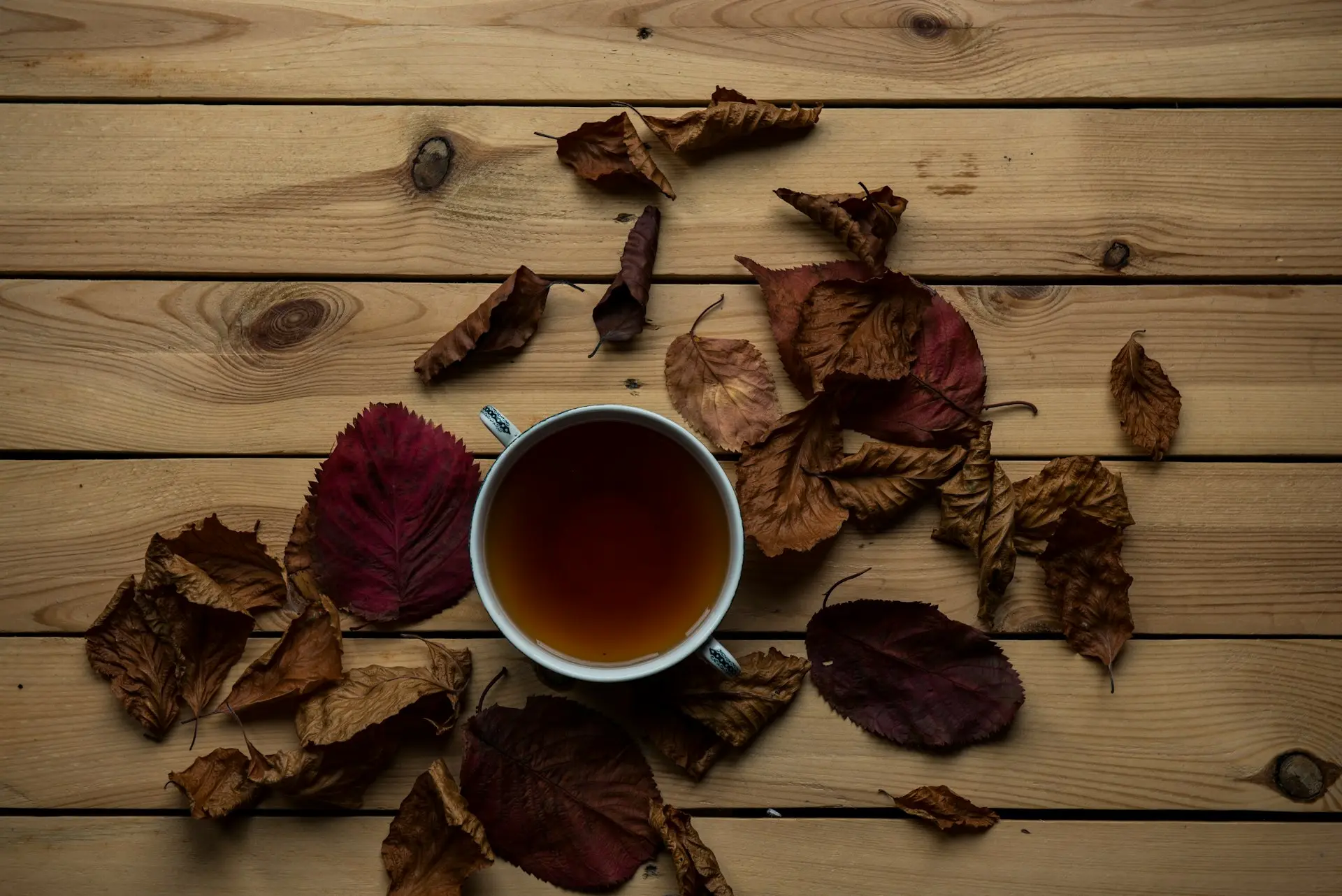 tea in cup on brown wooden surface